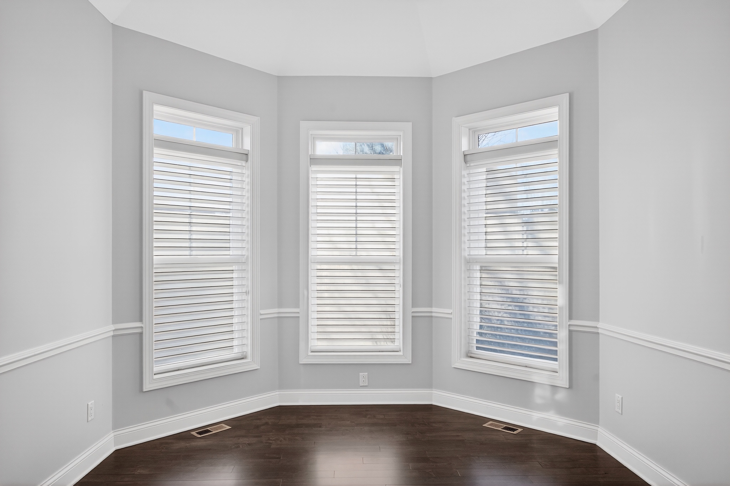 Sitting room with bay windows and plantation shutters