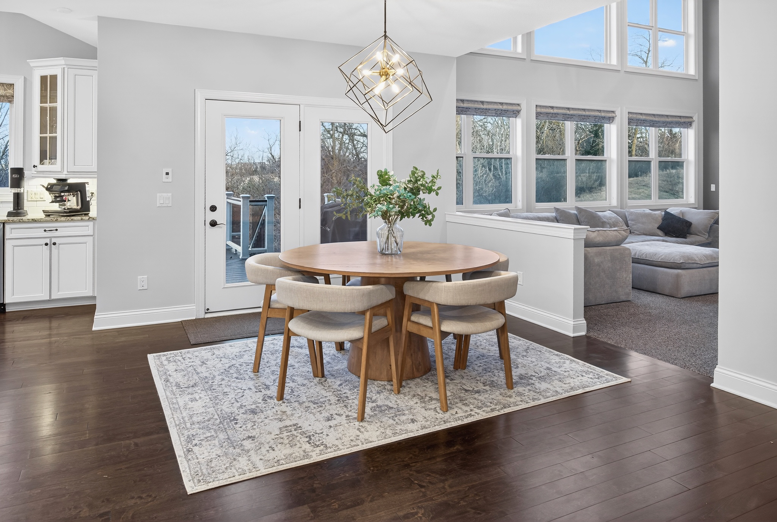 Open-concept breakfast nook with dining table overlooking great room