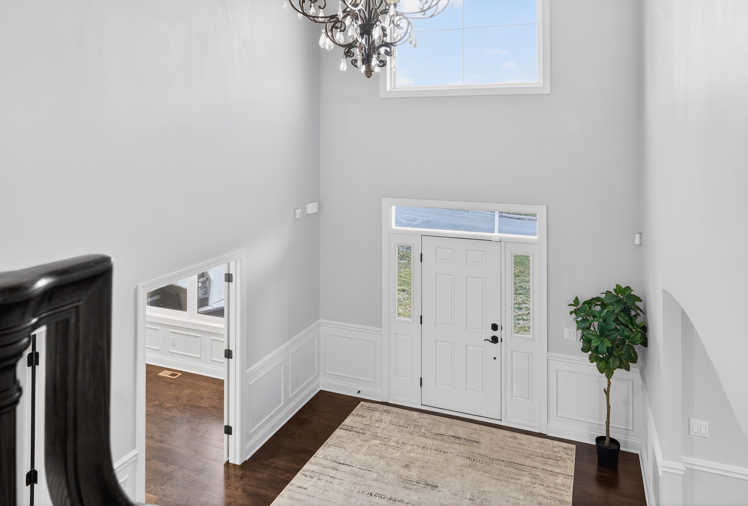 Primary bathroom with freestanding soaking tub, dual vanities, and tile floor