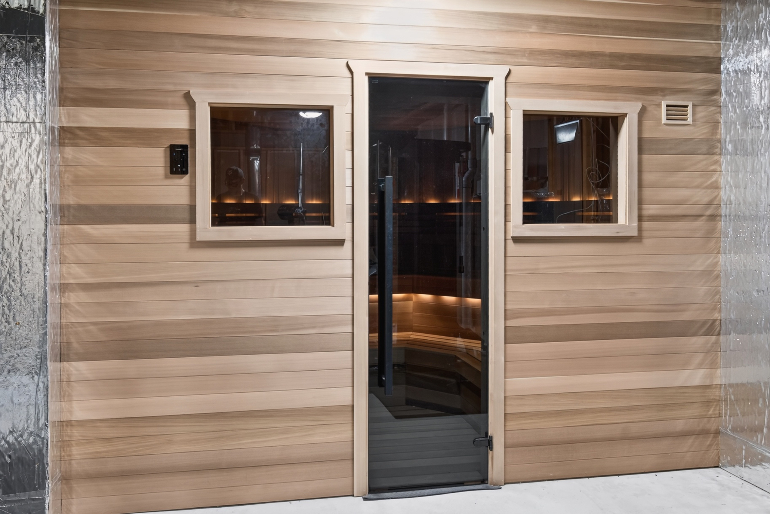 3-car garage with epoxy floors, built-in cabinetry, and Tesla EV charger