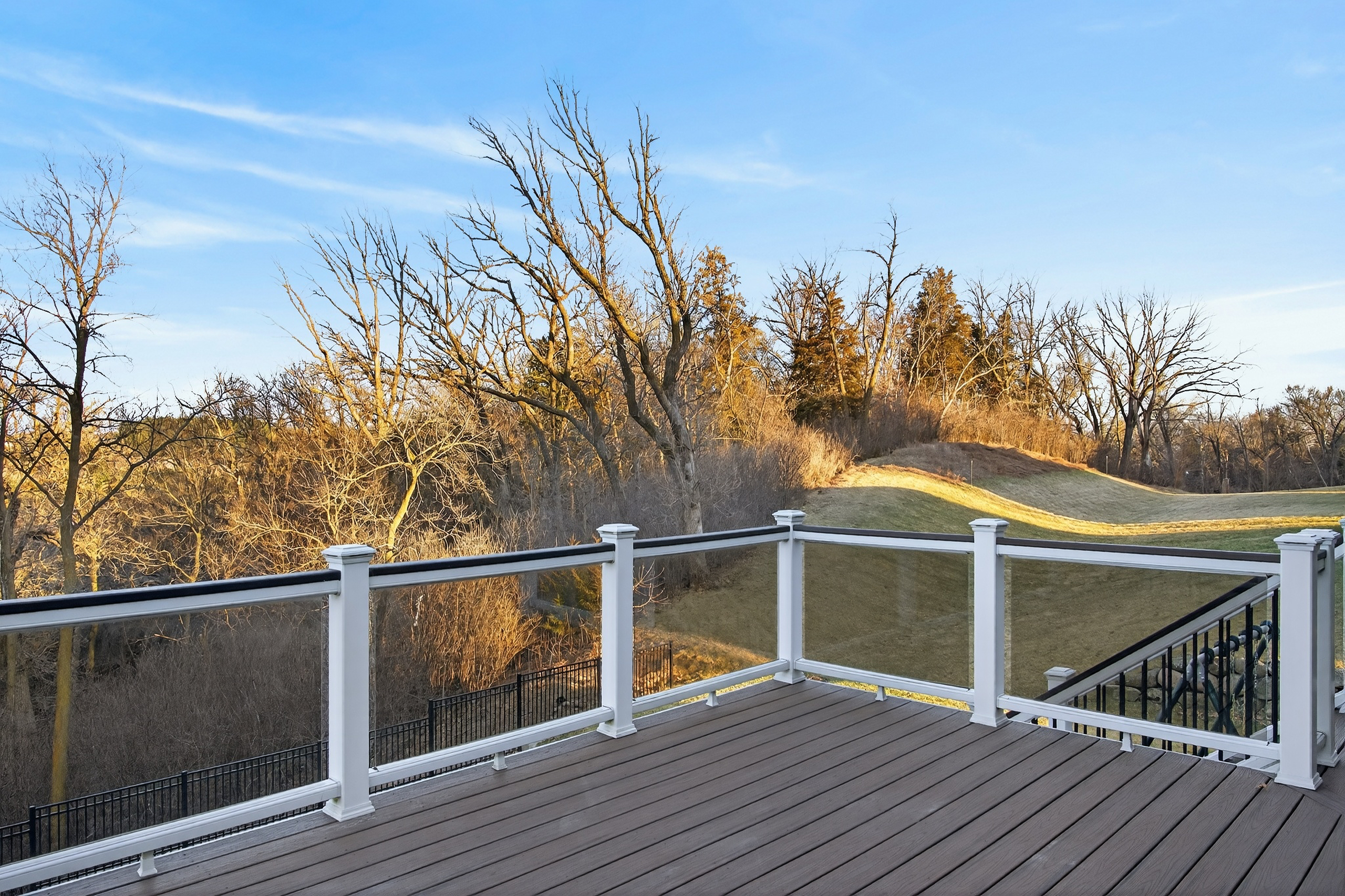 Exterior rear view showing walkout lower level and deck